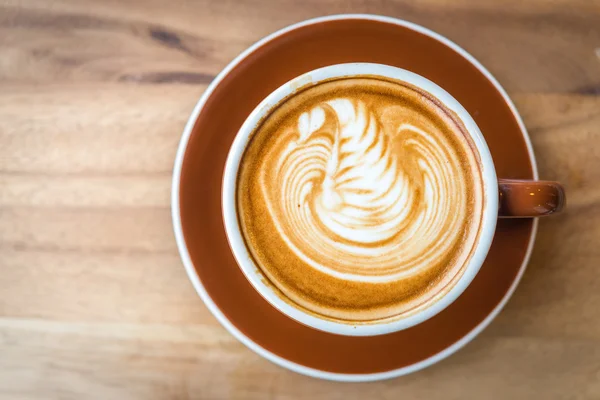 Coffee cup on wooden table — Stock Photo, Image