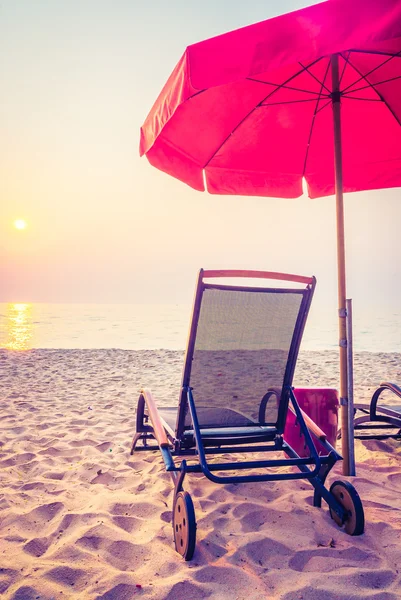 sun lounger on beach on sunset time