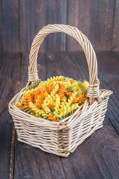 Raw pasta in basket — Stock Photo, Image