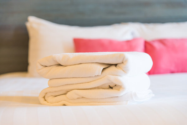 Towels on bed in bedroom