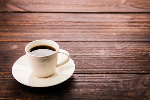 Coffee cup on wooden background — Stock Photo, Image