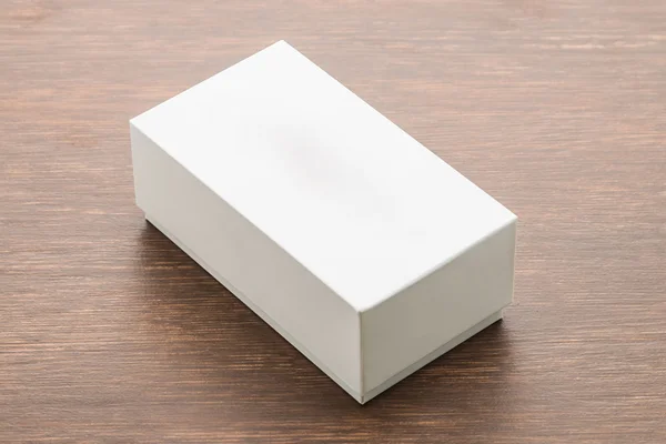 Blank box mock up on wooden background — Stock Photo, Image