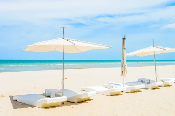 Зонтики и стулья на пляже — стоковое фото