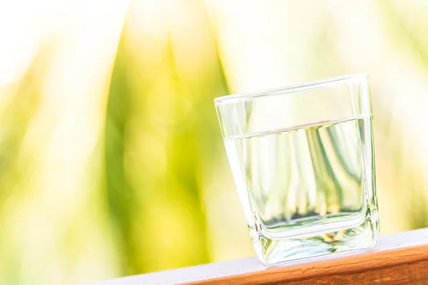 Glass of water on wooden surface — Stock Photo, Image