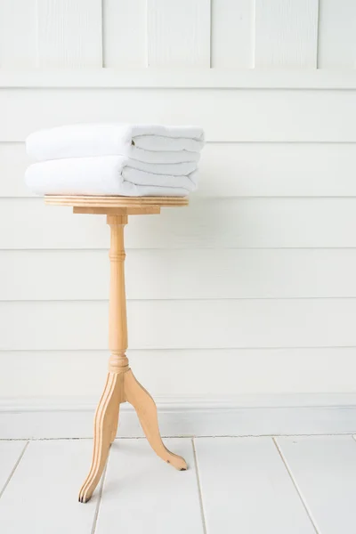 Towels in bath on wood table — Stock Photo, Image