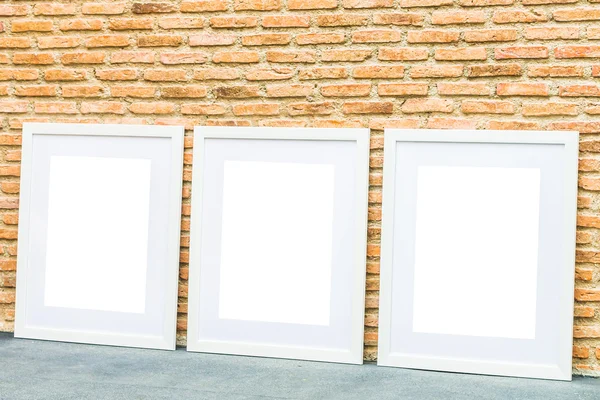 Blank frames on brick wall — Stock Photo, Image
