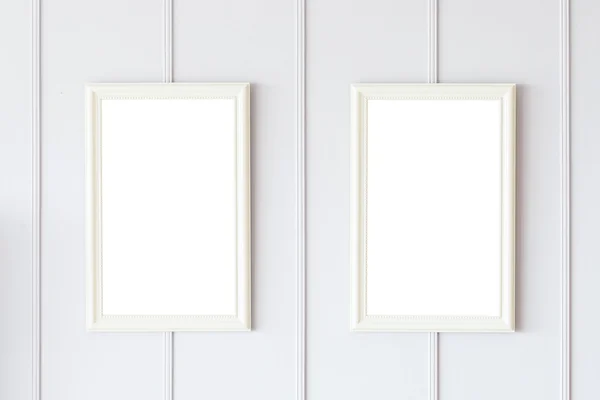 Blank frames on white wall — Stock Photo, Image