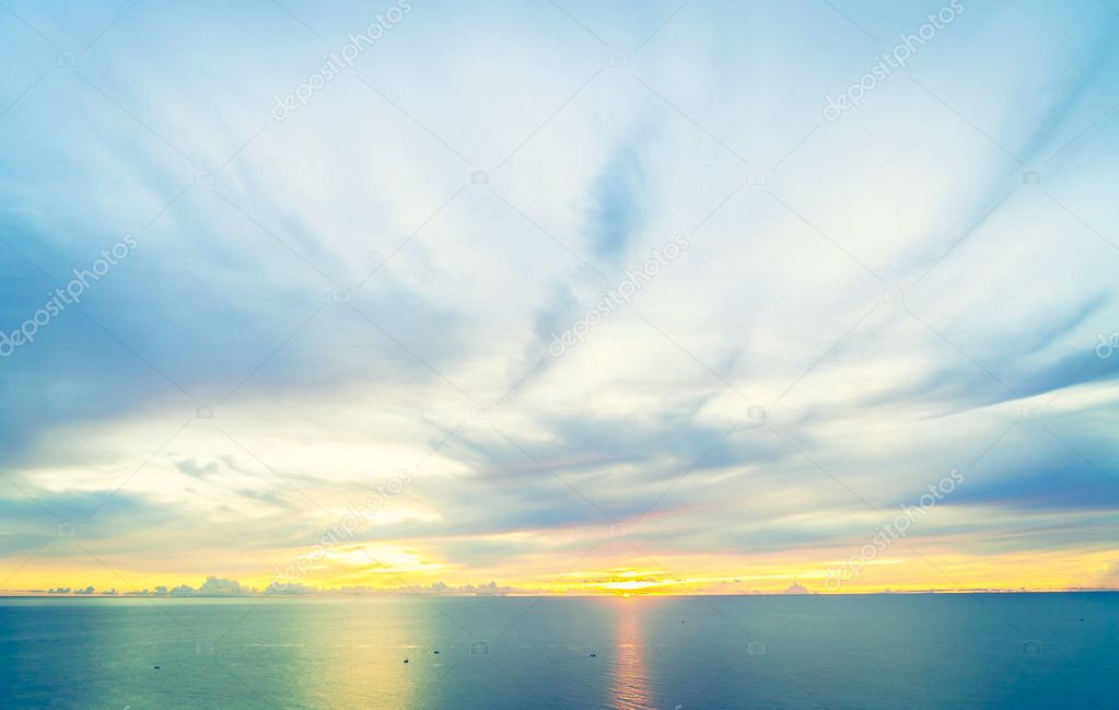 Sunrise with sea and cloudy sky