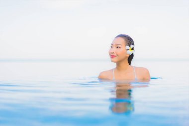 Güzel bir Asyalı kadın portresi. Rahat ol. Yüzme havuzu etrafında gülümse.