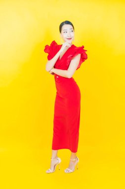 Portre güzel Asyalı kadın gülümsüyor. Renkli arka planda hareket var.