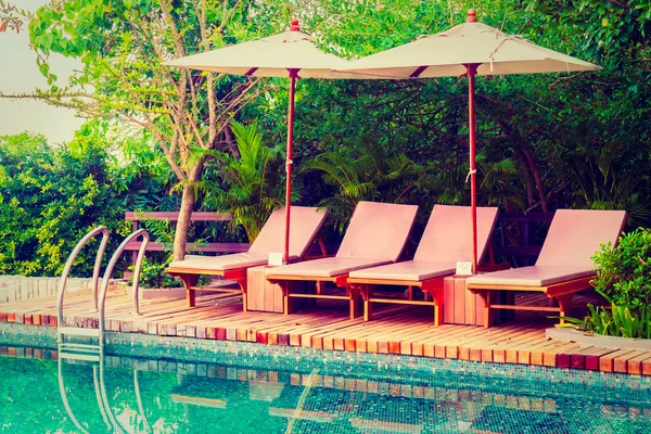 Umbrellas and chairs around swimming pool