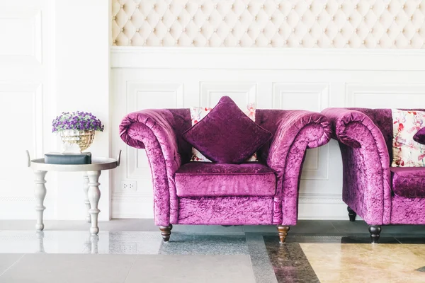Purple sofas with pillows