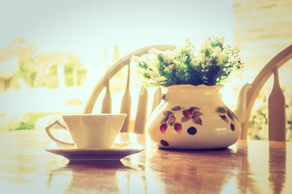 White coffee cup and vase plant