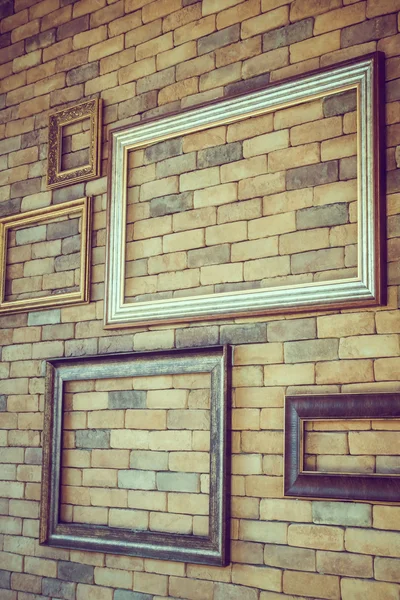 Empty photo frames on brick wall — Stock Photo, Image