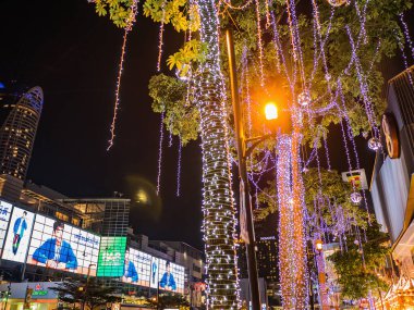 Bangkok/Thailand - 13 December 2018:Small neon light Wrap around and Hang on the Tree in front of Gaysorn Department Store at Bangkok city Thailand