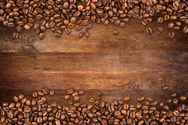Coffee beans old oak background — Stock Photo, Image