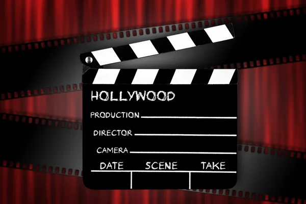 Clapperboard in front of red curtain — Stock Photo, Image