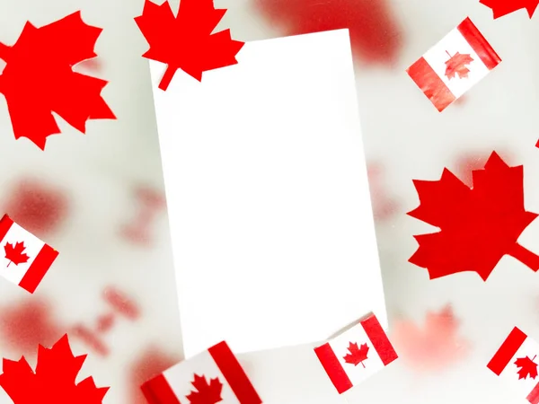 July 1, Happy Canada Day. Red maple leaves, flags and a white postcard on a transparent foggy background. The concept of freedom and patriotism, independence and victory. Mockup. Copy space. High quality photo