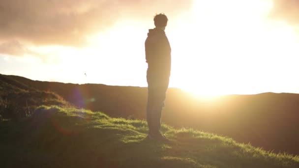 Olhar distante para o homem olhando para o pôr do sol — Vídeo de Stock