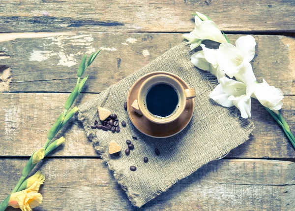 Cup coffee and flowers on a table