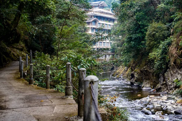 Mountain stream and forest buildings in Longsheng, Guangxi, China