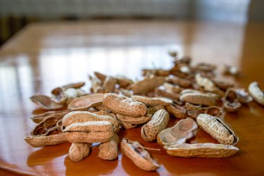 Close-up of a pile of finished peanut shells on the dining table
