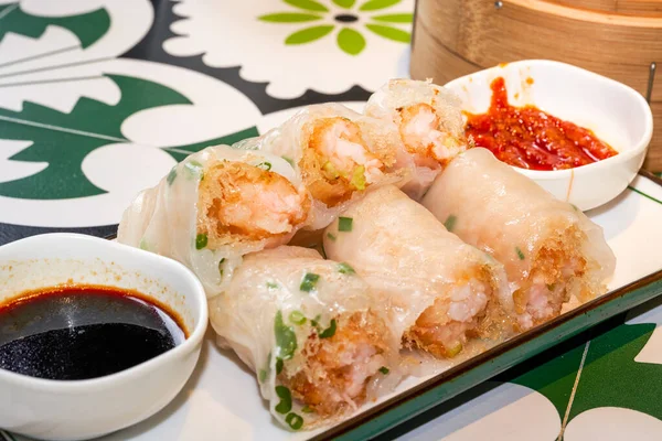 A plate of delicious Cantonese morning tea dim sum crispy shrimp rice rolls