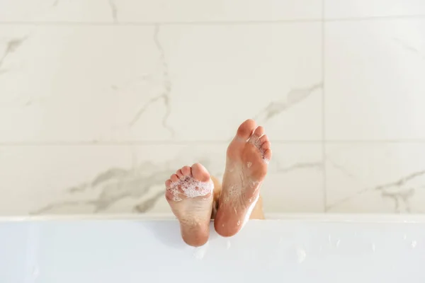 Feet lying in bubble bath
