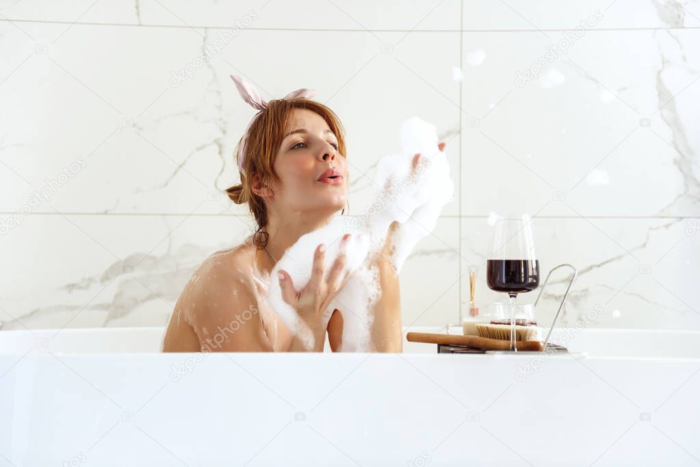 Woman lying in a bubble bath