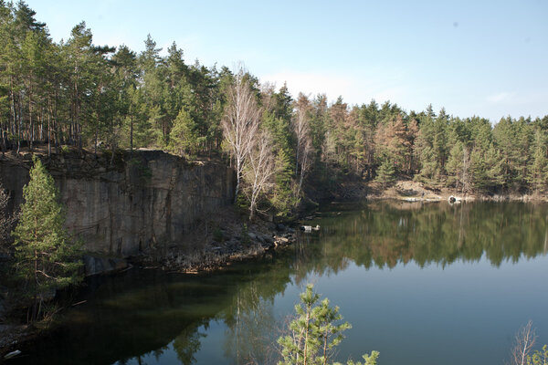 The lake is formed in place of the flooded granite quarry