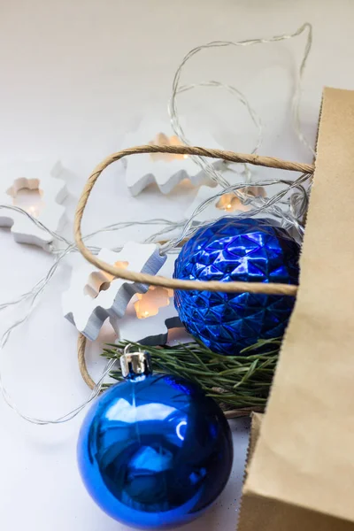 in a paper bag Christmas blue balls from the store on a white background