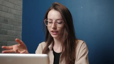 Happy young caucasian woman communicating by conference call speak looking at laptop at home office, video chat job interview.