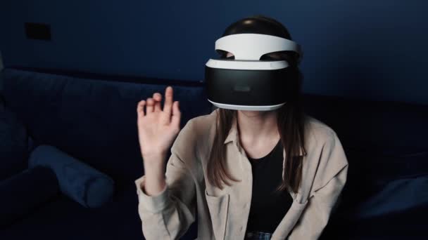 Mladá běloška v helmě VR dělá doma gesta rukou. Atraktivní žena těší virtuální realita kyberprostor. — Stock video