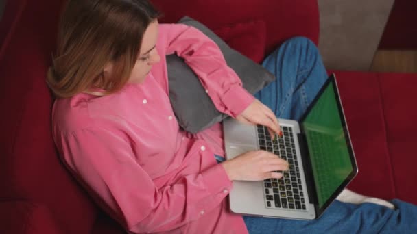 Bizneswoman pracuje nad laptopem zielony ekran chromakey na kanapie w domu. Dziewczyny piszą na laptopie zielony ekran slow motion. Zamknij się kobieta freelancer pisanie listu na laptopie w domu. — Wideo stockowe