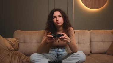 Sıkıcı kadın gece evde video oyunu oynarken esniyor. Kanepede oturup video oyunu oynayan sıkıcı oyuncu kadın..