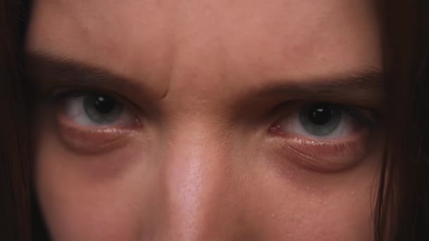 Detailní záběr ženské agresivní tváře, žena má krásné modré oči. Přírodní krása. Nádherná žena s dlouhými řasami a atraktivním vzhledem. Zpomalený pohyb. — Stock video