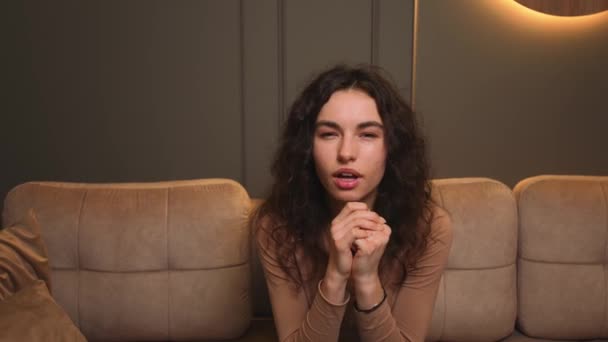 Excited young woman feel happy sit on couch, woman celebrate victory success, woman has good news at home. — Stock Video