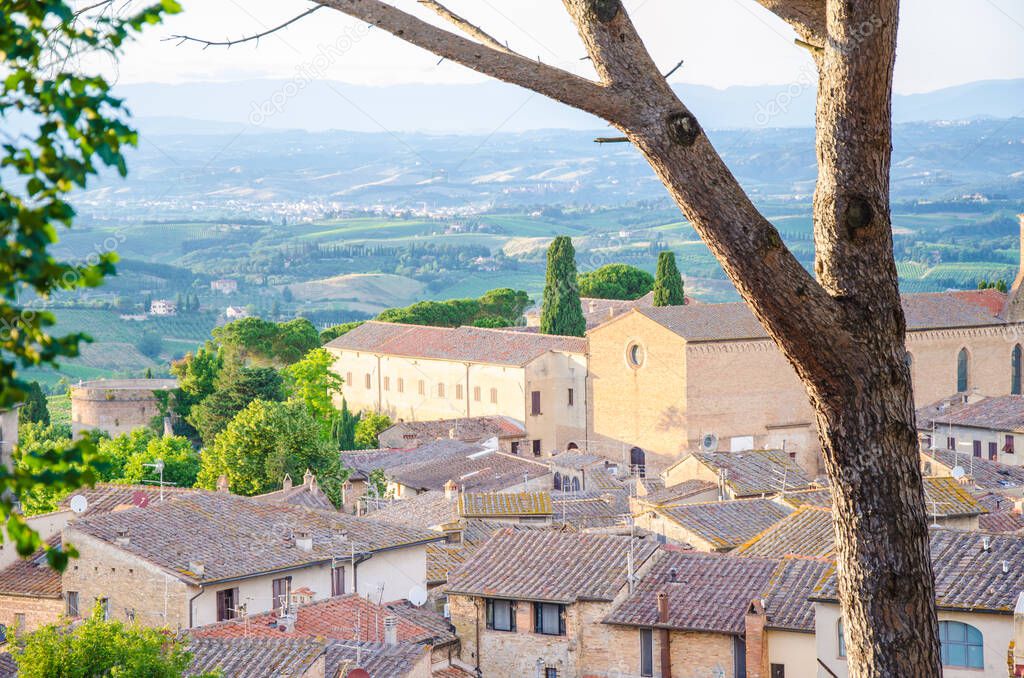 View of the historic town of San Gimignano with Tuscan countryside on a sunny day in summer, Tuscany, Italy
