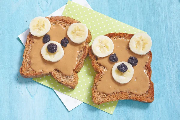 Funny bear face sandwich with peanut butter, banana and raisins — Stock Photo, Image