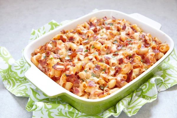 Casserole de pâtes avec bacon, jambon, fromage et tomate — Photo