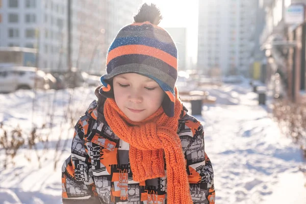 The boy holds snow in hands — Stock Photo, Image