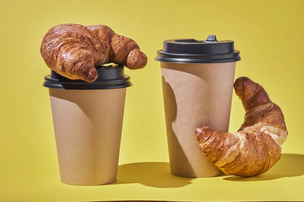 Take away coffee and fresh croissant