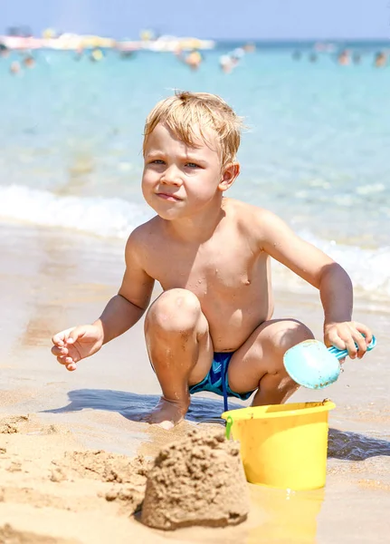 Menino brincando na areia na praia — Fotografia de Stock