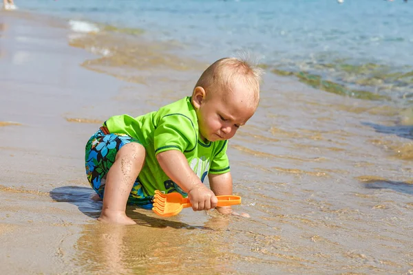 Ragazzo che gioca nella sabbia sulla spiaggia — Foto Stock