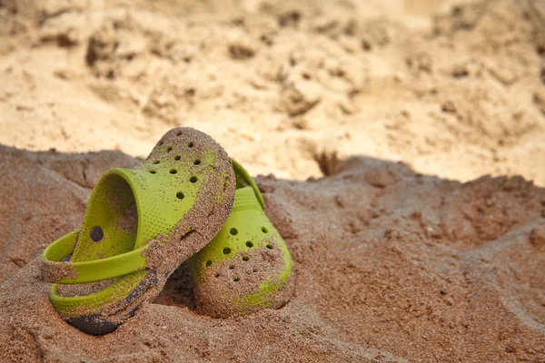 Green sandals on a beach — Stock Photo, Image