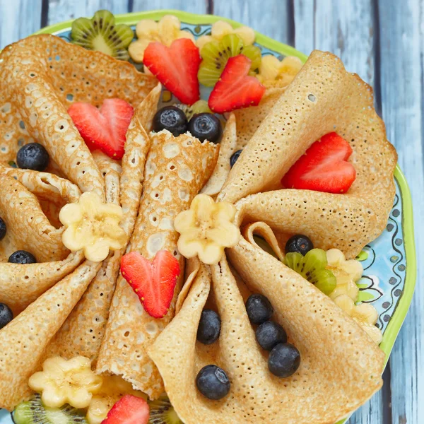 Funny butterfly shaped crepes with berries — Stock Photo, Image