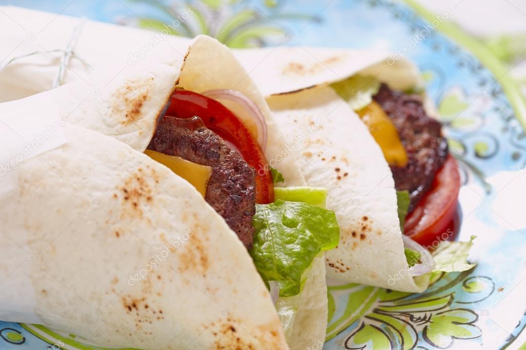 Fresh tortilla wrap with grilled beef burger