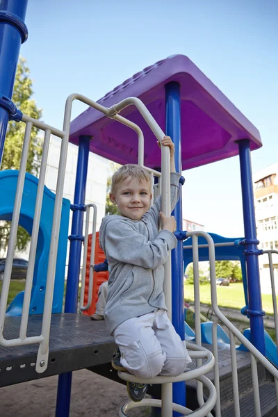 Kleiner Junge spielt auf einem Spielplatz — Stockfoto