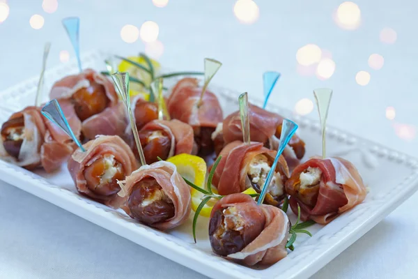 Dates stuffed cheese and wrapped prosciutto — Stock Photo, Image