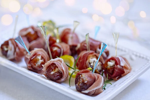 Dates stuffed cheese and wrapped prosciutto — Stock Photo, Image